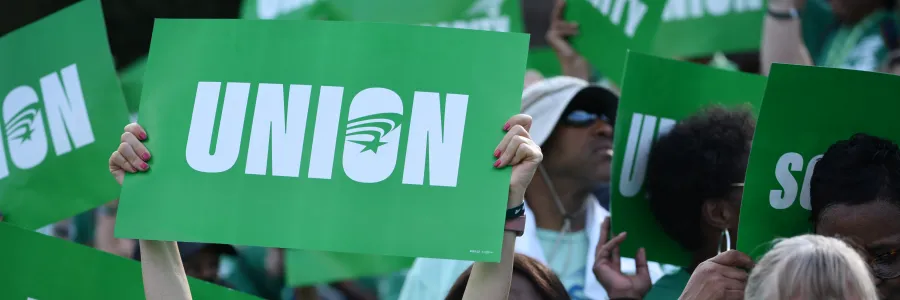 AFSCME member holding sign